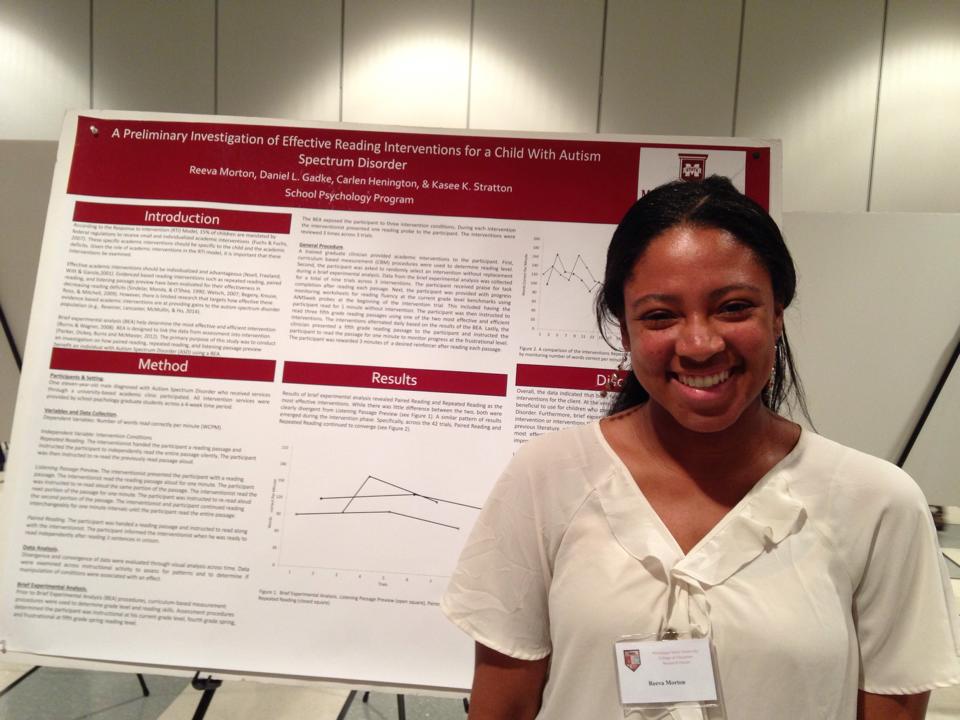 Student Standing in front of psychology poster
