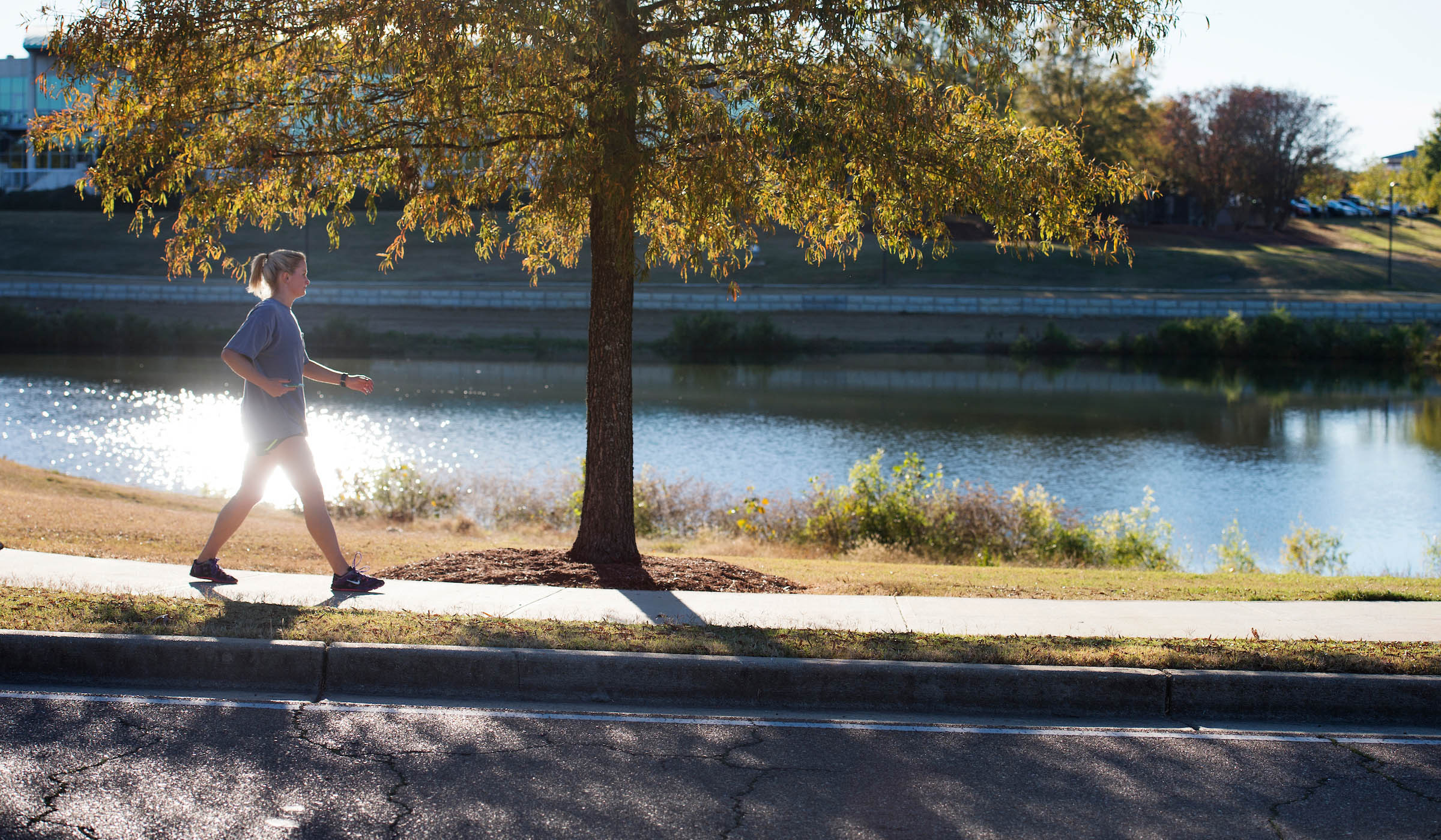 Woman jogging in front of a lake