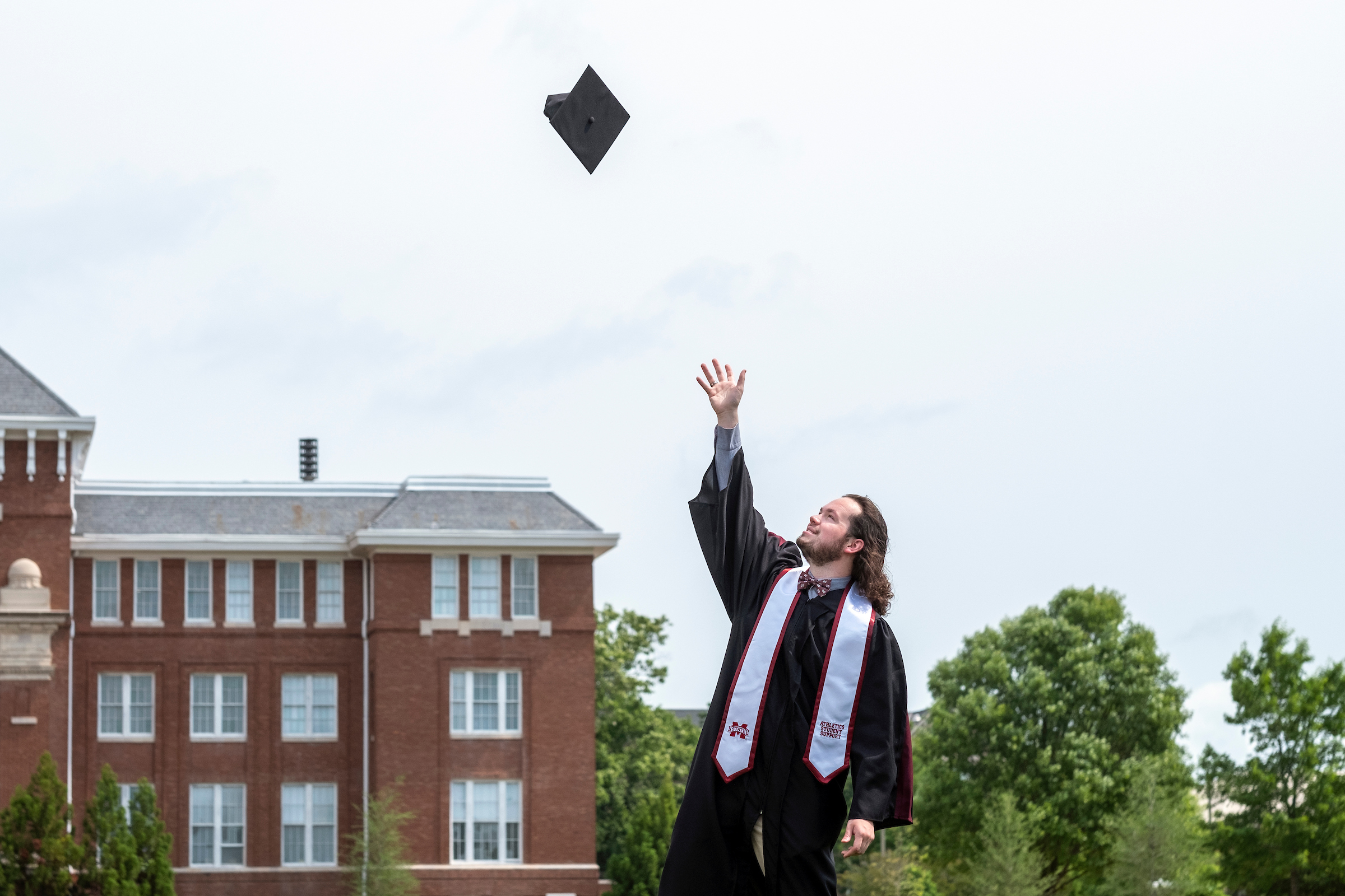 Student throws his cap in air on Drill Field